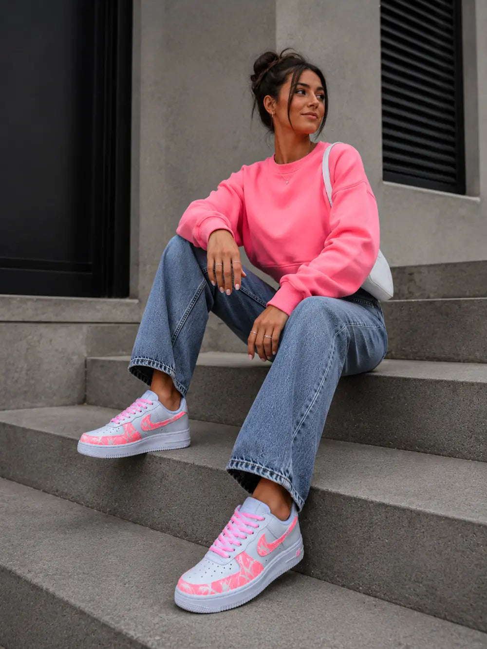 Nike Air Force 1 corail custom femme portée assise avec tenue casual streetwear, baskets personnalisées artisanales haut de gamme.