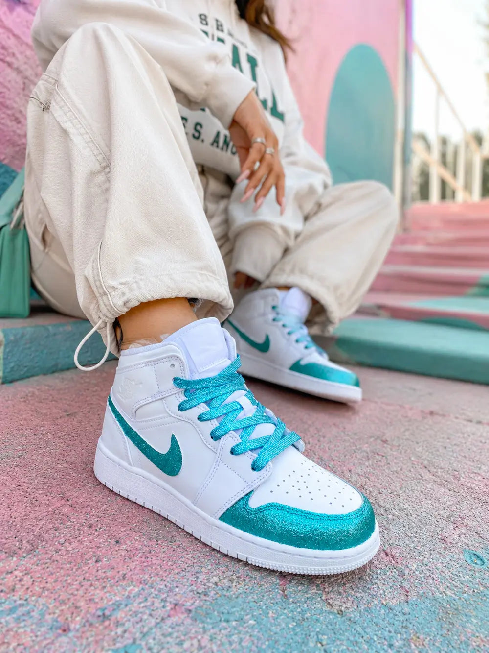Nike Air Jordan personnalisée turquoise pailleté portée par une femme avec outfit oversize streetwear chic