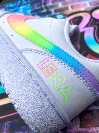 Sur cette image, une paire de baskets Nike multicolores avec un effet fluo et arc-en-ciel pour un style fun et dynamique.