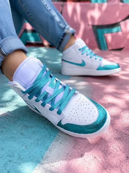 Basket femme Air Jordan 1 Mid blanche et turquoise glitter portée en look urbain casual premium