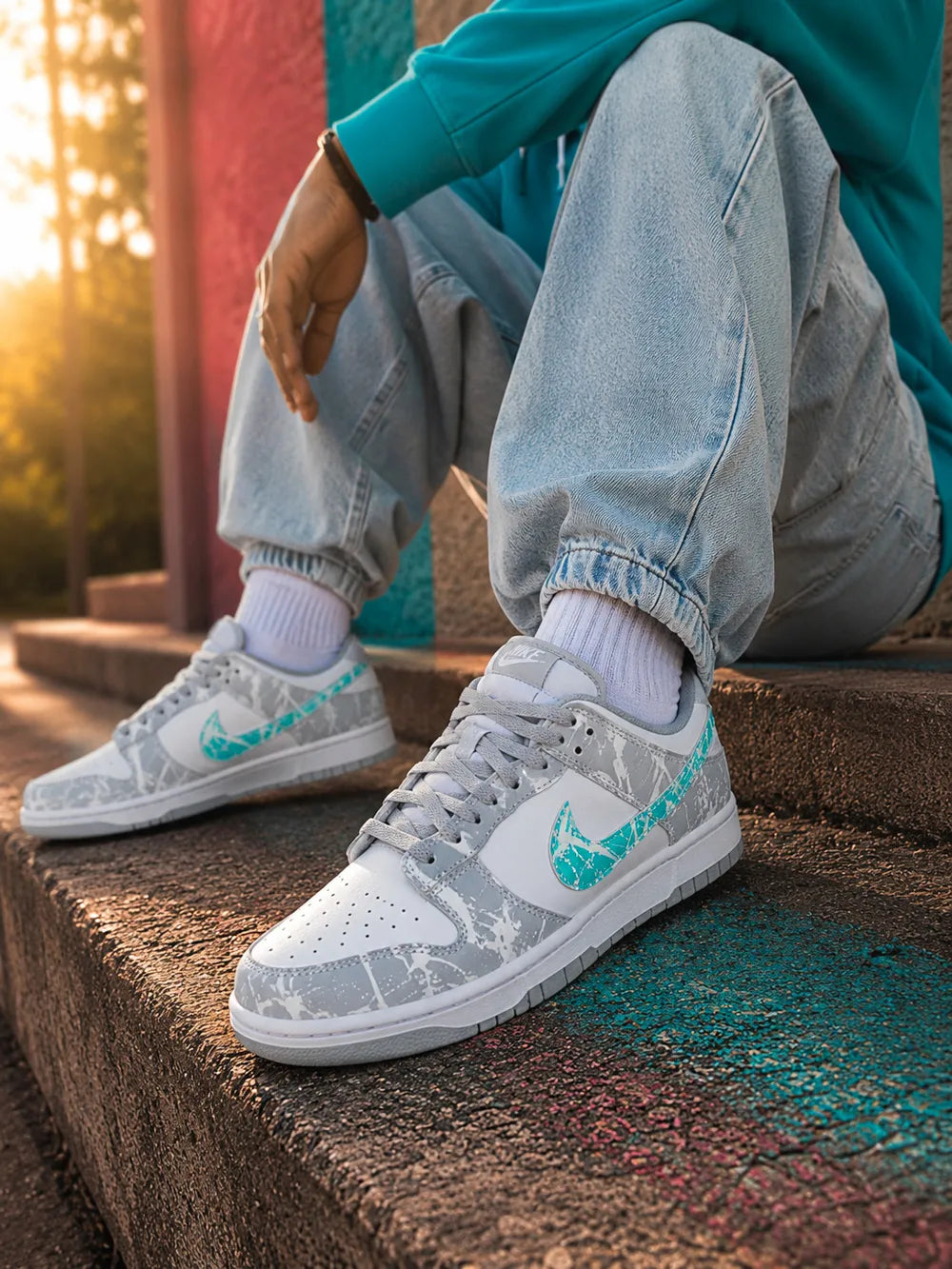 Nike Dunk custom gris et turquoise portées avec une tenue streetwear moderne pour femme.